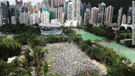 Protesters waved placards and wore white -- the designated color of the rally. "Hong Kong, never give up!" some chanted.