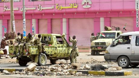 TOPSHOT - Sudanese soldiers stand guard a street in Khartoum on June 9, 2019. - Sudanese police fired tear gas Sunday at protesters taking part in the first day of a civil disobedience campaign, called in the wake of a deadly crackdown on demonstrators. Protesters gathered tyres, tree trunks and rocks to build new roadblocks in Khartoum&#39;s northern Bahari district, a witness told AFP, but riot police swiftly moved in and fired tear gas at them. (Photo by - / AFP)        (Photo credit should read -/AFP/Getty Images)