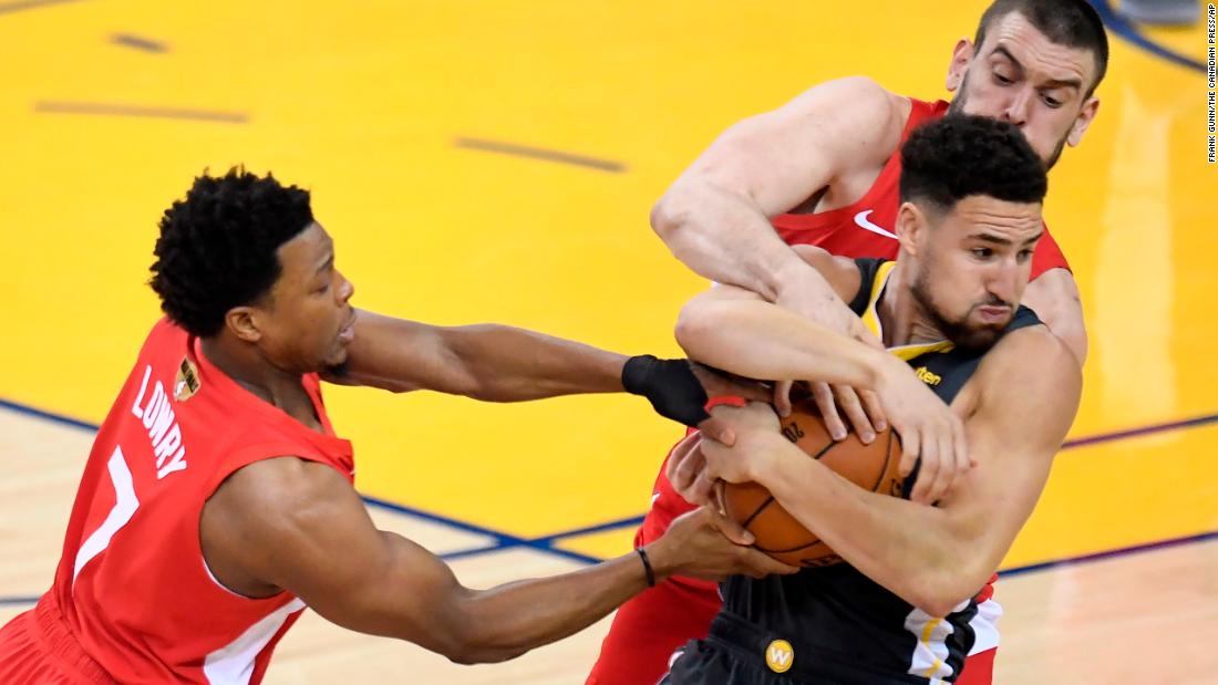 Lowry, left, and Marc Gasol double-team Thompson during Game 4 on Friday, June 7. The Raptors frustrated the high-powered Warriors en route to a 105-92 victory.