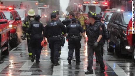 New York police and firefighters arrive at the helicopter crash scene Monday in Midtown Manhattan.