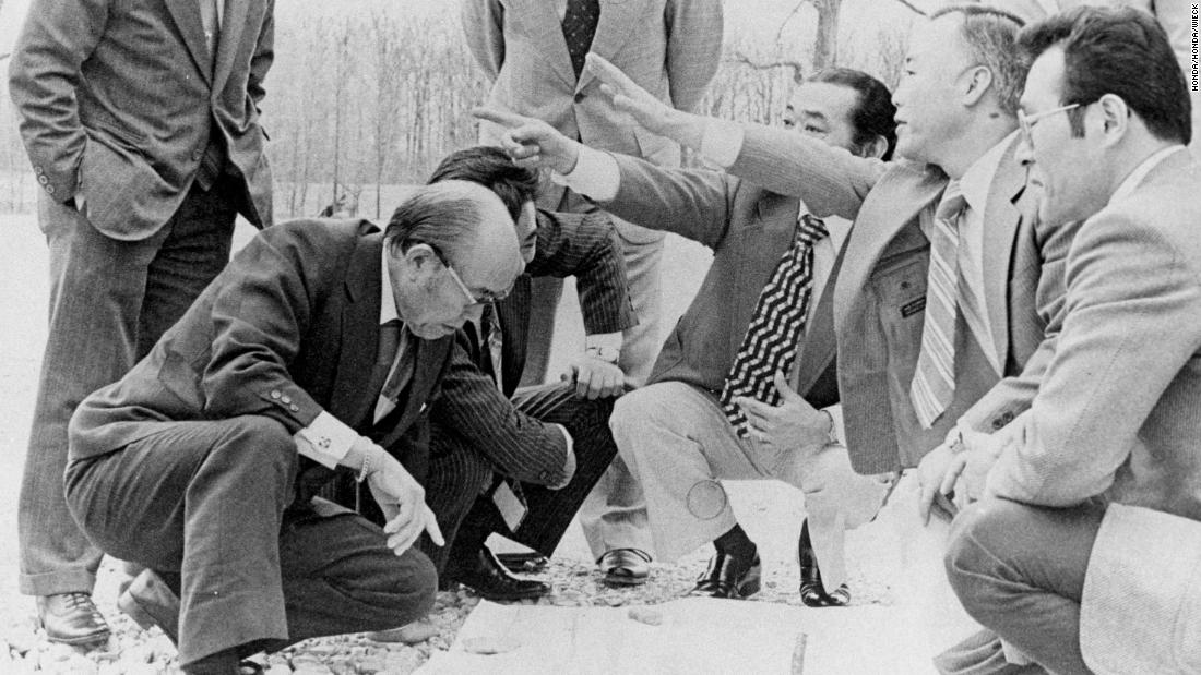 Soichiro Honda, the founder of Honda Motor, inspects plans for the construction of the new motorcycle plant in Marysville.