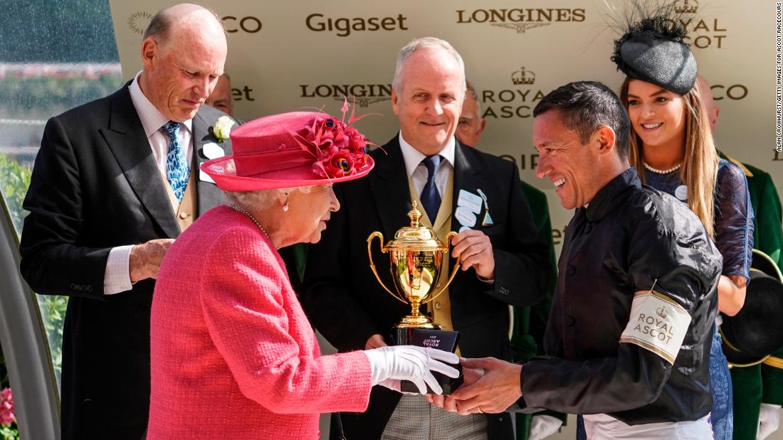 Britain&#39;s Queen Elizabeth II presents Frankie Dettori with his prize after he rode Stradivarius to win Ascot Gold Cup on day three of the royal meeting in 2018.