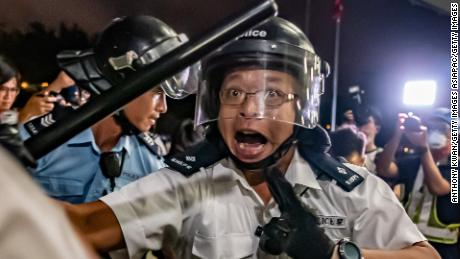 HONG KONG, HONG KONG - JUNE 10: Police officers charge toward protesters after a rally against the extradition law proposal at the Central Government Complex on June 10, 2019 in Hong Kong. Organizers say more than a million marched on Sunday against a bill that would allow suspected criminals to be sent to mainland China for trial as tensions have escalated in recent weeks. (Photo by Anthony Kwan/Getty Images)