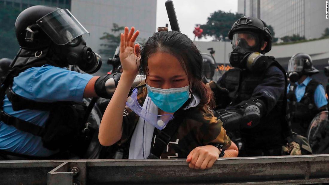 A protester reacts as she is grabbed by police on June 12.