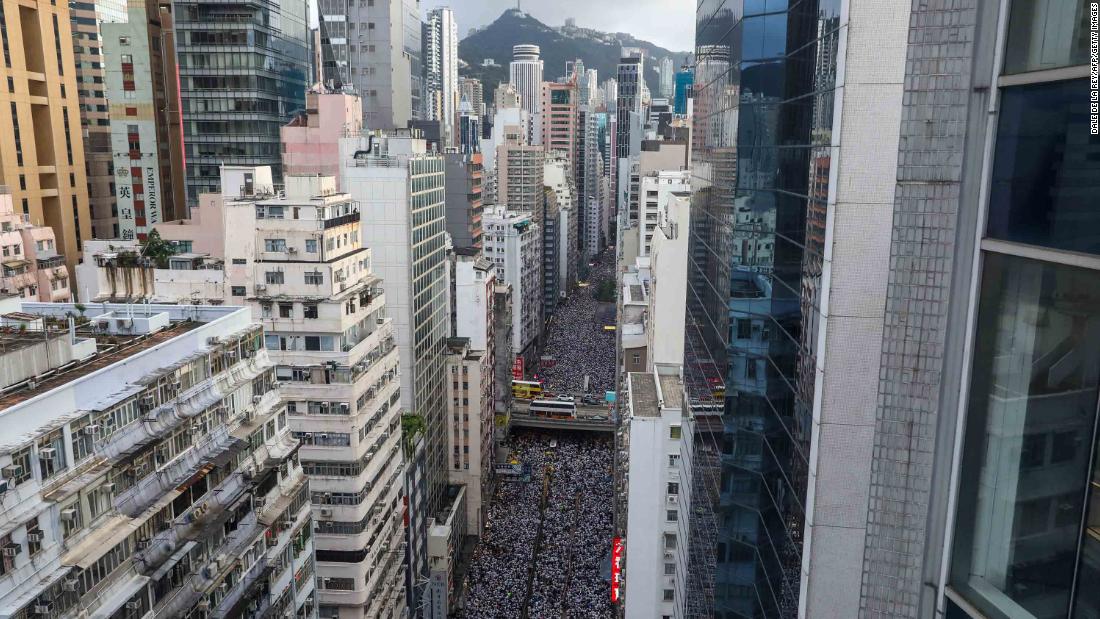 Protesters on June 9 waved placards and wore white -- the designated color of the rally. "Hong Kong, never give up!" some chanted.