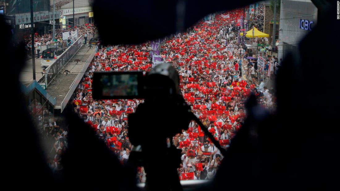 A police camera films the rally on Sunday, June 9.