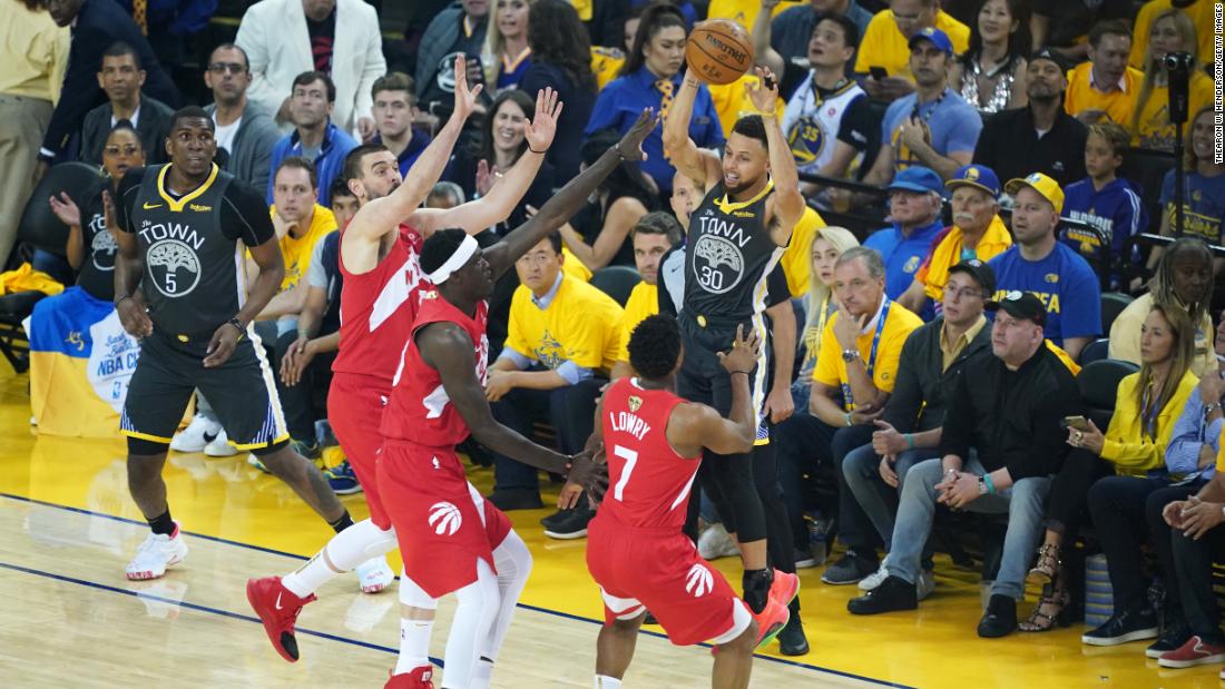 Three Raptors defend Stephen Curry in the first half of Game 6.