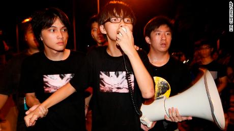 Leader of the student group &quot;Scholarism,&quot; Joshua Wong speaks to tens of thousands protesters outside the government headquarters in Hong Kong, in September 2012. 