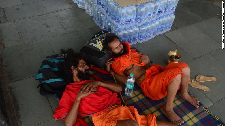 Passengers rest near water bottles at Allahabad railway station in Uttar Pradesh, India on June 11, 2019. 