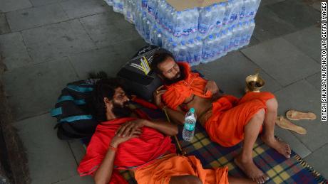 Passengers rest near water bottles at Allahabad railway station in Uttar Pradesh, India on June 11, 2019.  