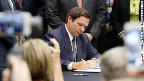 Florida Gov. Ron DeSantis signs a bill banning sanctuary cities on Friday.