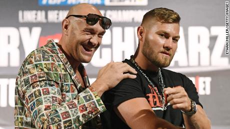 Boxers Tyson Fury (left) and Tom Schwarz pose ahead of their heavyweight bout.