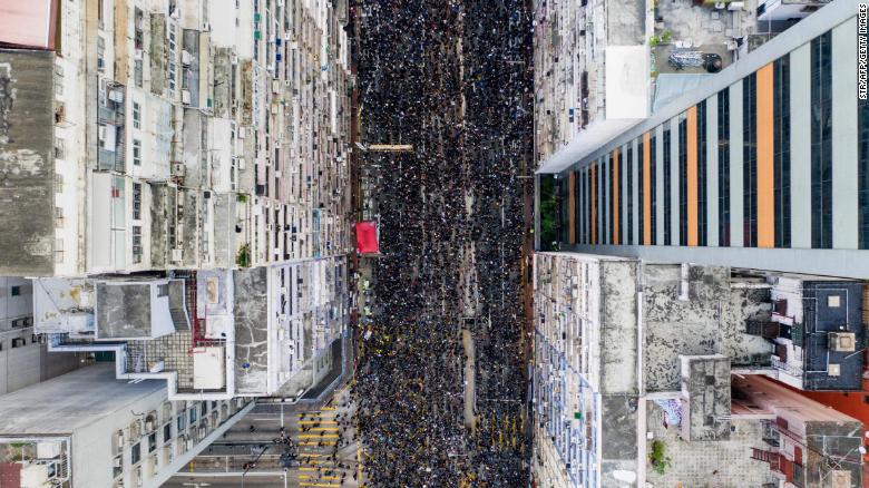 An overhead view shows thousands of protesters marching through a Hong Kong street to protest a controversial extradition bill on Sunday, June 16.