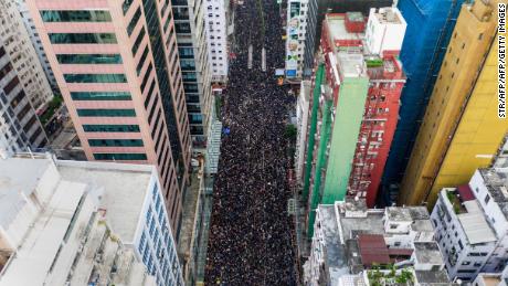 TOPSHOT - This overhead view shows thousands of protesters marching through the street as they take part in a new rally against a controversial extradition law proposal in Hong Kong on June 16, 2019. - Tens of thousands of people rallied in central Hong Kong on June 16 as public anger seethed following unprecedented clashes between protesters and police over an extradition law, despite a climbdown by the city&#39;s embattled leader. (Photo by STR / AFP)        (Photo credit should read STR/AFP/Getty Images)
