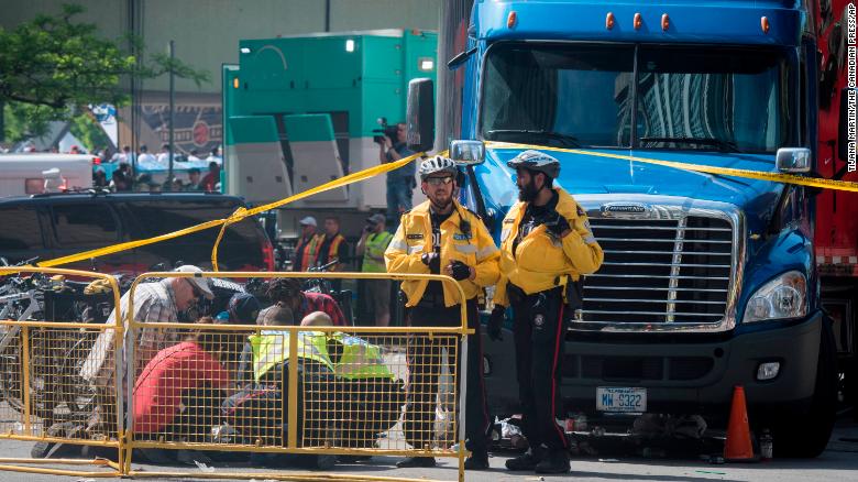 First responders attend to an injured person after shots were fired during the Toronto Raptors NBA championship victory celebration/