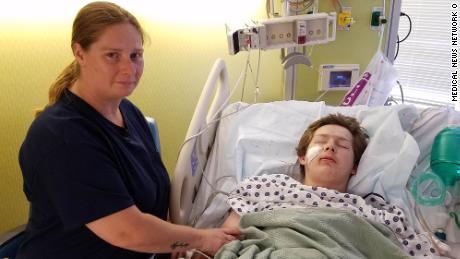 Eli Gregg recovering at the hospital with his mother, Jimmy Russell, by his side.