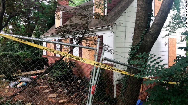 Police tape surrounds the house where Askia Khafra died in a fire while digging tunnels.