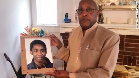 Dia Khafra, father of Askia Khafra, holds a photo of his son in his Silver Springs, Maryland, home. 