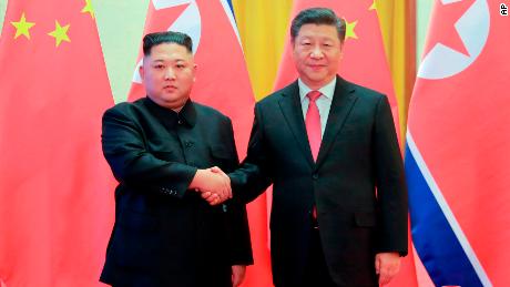 In this Jan. 8 photo provided by the North Korean government, North Korean leader Kim Jong Un, left, and Chinese President Xi Jinping pose for photographs at the Great Hall of the People in Beijing. 