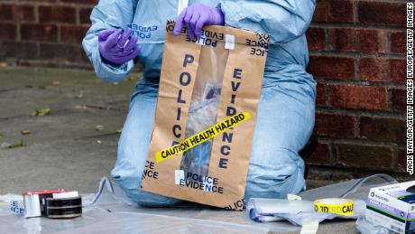 Forensics teams work at the scene of a stabbing in Edmonton, London, on March 31, 2019.