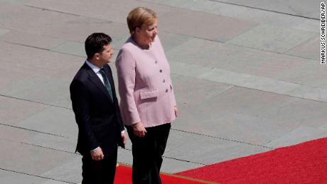 Angela Merkel says she is &#39;very well&#39; after visibly shaking during ceremony