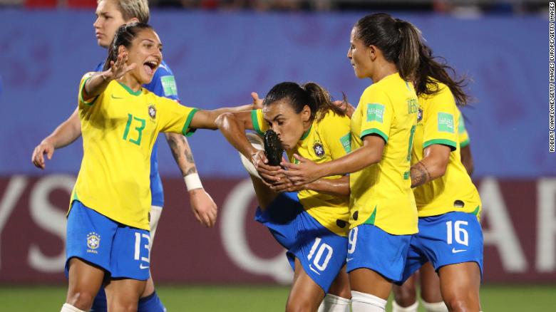 Marta kisses her boot after becoming the first player to score in five Women&#39;s World Cup tournaments. 