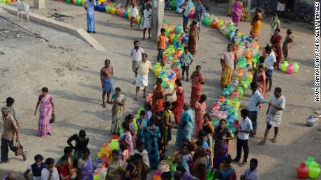 Indian residents queue to get drinking water from a distribution tanker in the outskirts of Chennai on May 29, 2019.