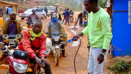 A taxi driver gets his hands washed with a chlorine solution at a checkpoint between Beni and Butembo in Eastern DRC. 