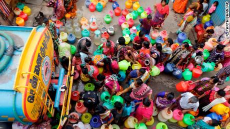 Chennai residents line up to fill vessels with water from a tanker.