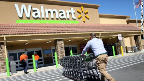 MIAMI, FL - FEBRUARY 19:  Walmart employee Yurdin Velazquez pushes grocery carts at a Walmart store on February 19, 2015 in Miami, Florida.  The Walmart company announced Thursday that it will raise the wages of its store employees to $10 per hour by next February, bringing pay hikes to an estimated 500,000 workers. (Photo by Joe Raedle/Getty Images)