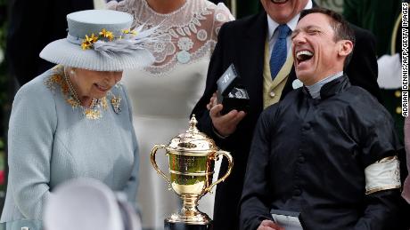 Britain&#39;s Queen Elizabeth II presents the Gold Cup to Frankie Dettori on day three at Royal Ascot.