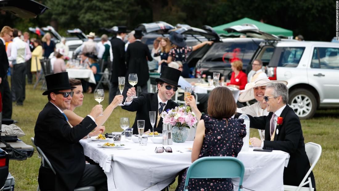 After a wet week, the sun is out at Ascot and racegoers are able to enjoy picnics in the car park.