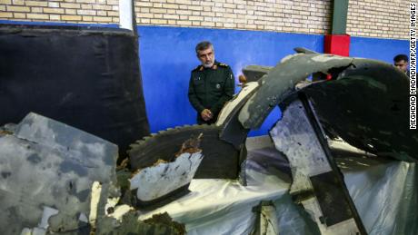 Gen. Amir Ali Hajizadeh, Iran&#39;s head of the Revolutionary Guard&#39;s aerospace division, looks at debris from a downed US drone on June 21, 2019.