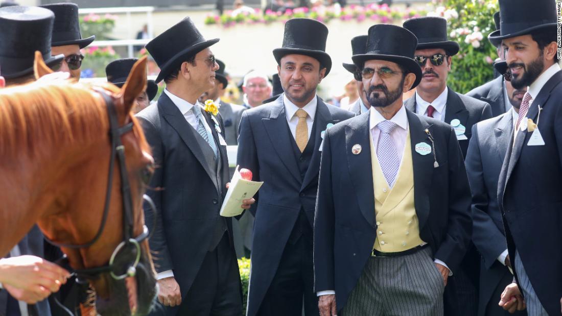 Dubai ruler Sheikh Mohammed bin Rashid Al Maktoum (yellow waistcoat) is head of the Godolphin racing operation and a familiar face at British horse racing tracks. 
