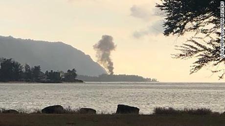 A plume of smoke rises after the plane crash at Dillingham Airfield on Oahu&#39;s North Shore. 