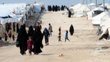 Veiled women, living in al-Hol camp which houses relatives of ISIS group members, walk in the camp in al-Hasakeh governorate in northeastern Syria on March 28, 2019. 