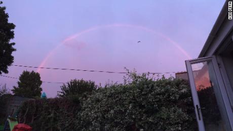 A pink rainbow arcs over Bristol, England.