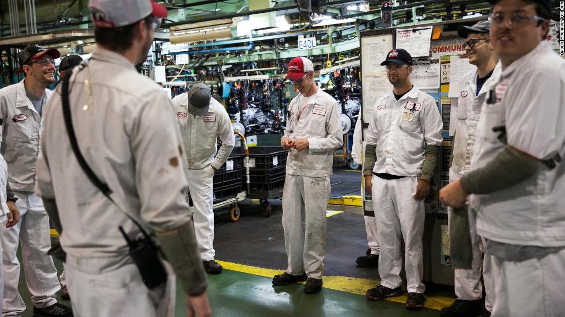 Associates gather for a pre-shift meeting. Everyone at Honda dresses in white.