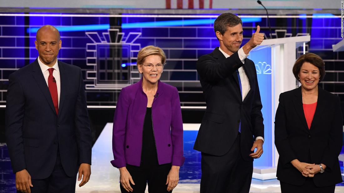 From left, Booker, Warren, O&#39;Rourke and Klobuchar pose on stage before the start of the debate Wednesday.