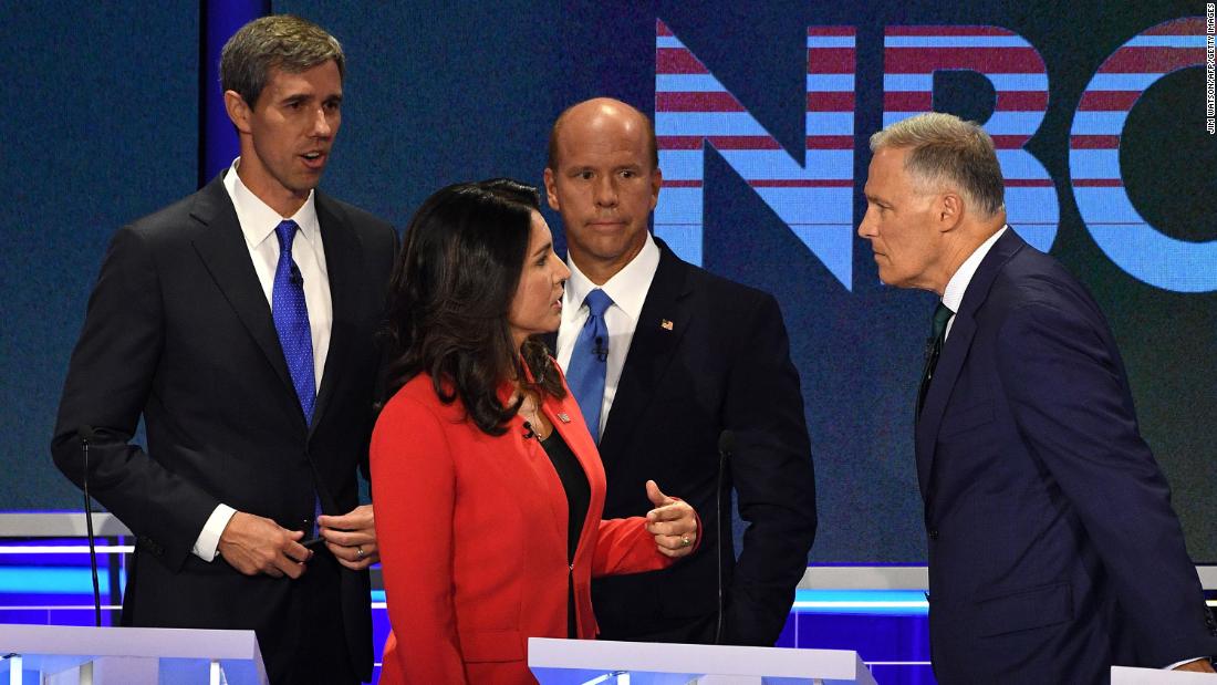 Gabbard speaks with Inslee during a commercial break Wednesday.