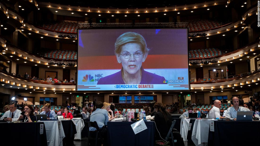 Warren is displayed on a monitor inside the spin room at the Arsht Center. The US senator from Masschusetts is &lt;a href=&quot;https://www.cnn.com/politics/live-news/democratic-debate-june-26-2019/h_f7eb98576555e7400b94bb91b965b44b&quot; target=&quot;_blank&quot;&gt;the only candidate from Wednesday&#39;s debate who is polling above 5%.&lt;/a&gt; She became a progressive star by taking on Wall Street after the 2007 financial crisis.