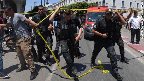 Tunisian police work at the site of one of  Thursday's attacks.