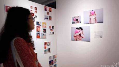 A visitor attends this year&#39;s Pride Art Opening at Polar Bear Gallery in Shanghai. 