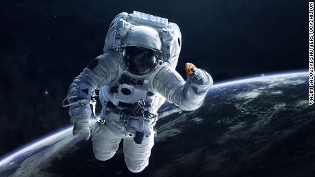 In this photo illustration provided in a press release by DoubleTree, an astronaut holds a cookie in space. 