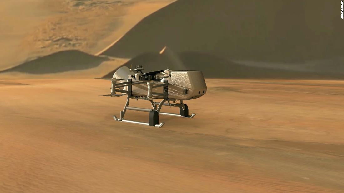 This illustration shows NASA's Dragonfly rotorcraft-lander approaching a site on Saturn's exotic moon, Titan. Taking advantage of Titan's dense atmosphere and low gravity, Dragonfly will explore dozens of locations across the icy world, sampling and measuring the compositions of Titan's organic surface materials to characterize the habitability of Titan's environment and investigate the progression of prebiotic chemistry.