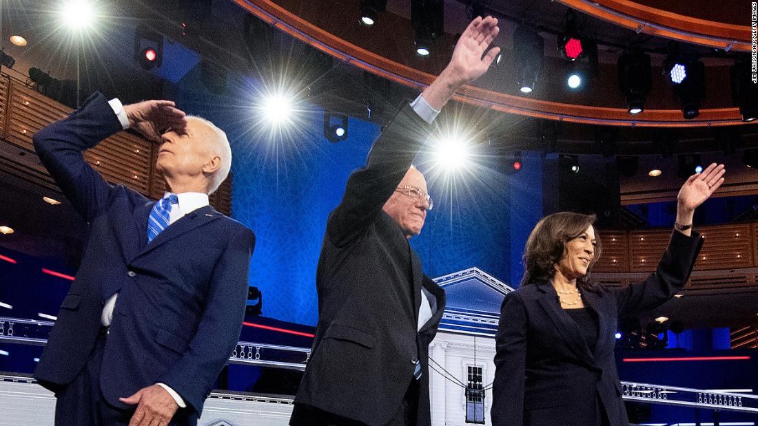 From left, Biden, Sanders and Harris arrive on stage for Thursday&#39;s debate.