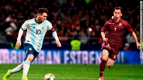 Argentina's forward Lionel Messi (L) runs with the ball next to Venezuela's midfielder Juanpi during an international friendly football match between Argentina and Venezuela at the Wanda Metropolitano stadium in Madrid on March 22, 2019 in preparation for the Copa America to be held in Brazil in June and July 2019. (Photo by PIERRE-PHILIPPE MARCOU / AFP)        (Photo credit should read PIERRE-PHILIPPE MARCOU/AFP/Getty Images)