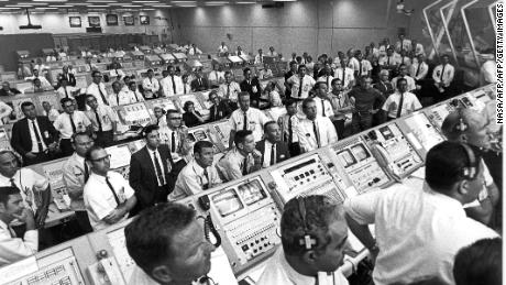 Members of the Kennedy Space Center control room team rise from their consoles to see the liftoff of the Apollo 11 mission 16 July 1969.  AFP PHOTO/NASA (Photo by NASA / NASA / AFP)        (Photo credit should read NASA/AFP/Getty Images)