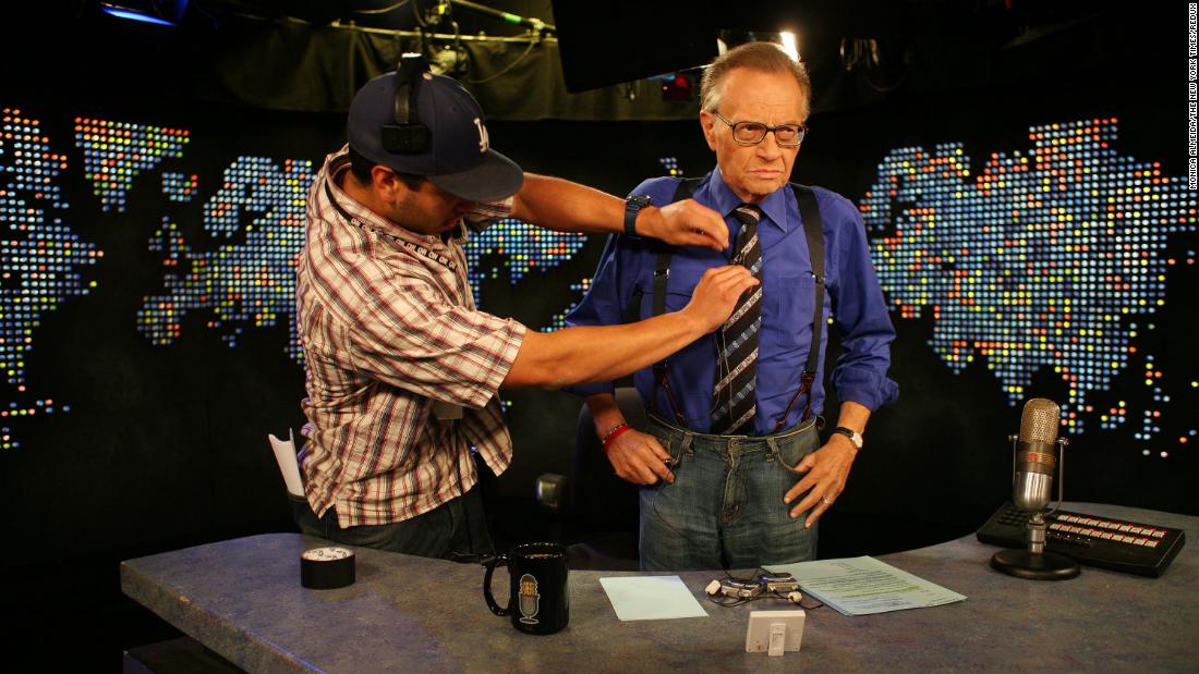 King has his microphone adjusted on the set of his show in 2007.