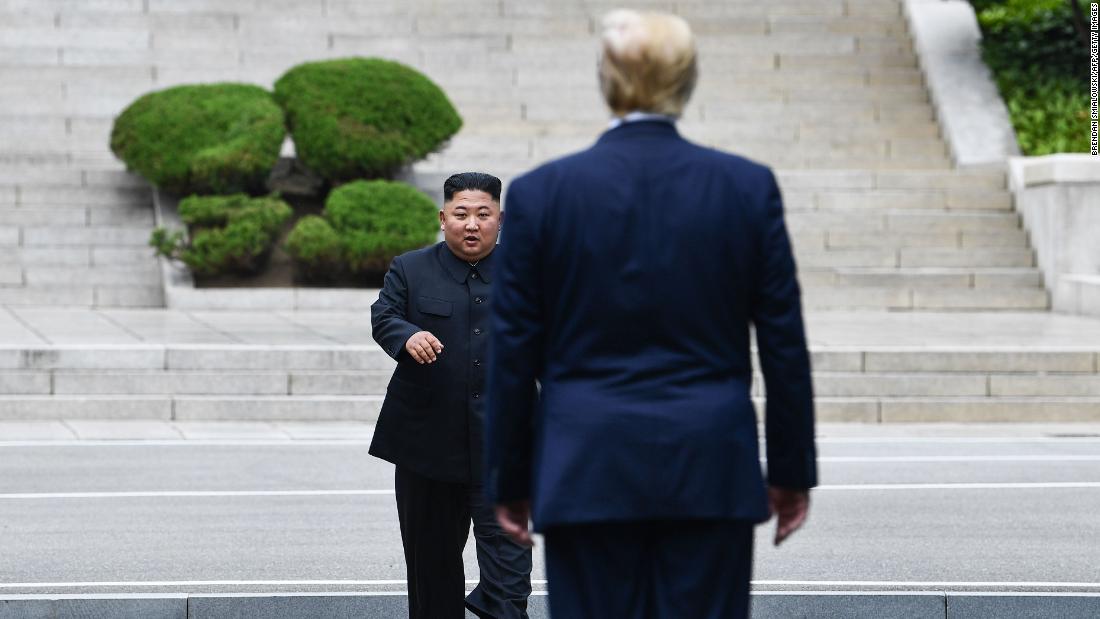 North Korea's leader Kim Jong Un walks to greet US President Donald Trump at the Military Demarcation Line that divides North and South Korea, in the Joint Security Area (JSA) of Panmunjom in the Demilitarized Zone (DMZ) on Sunday, June 30.